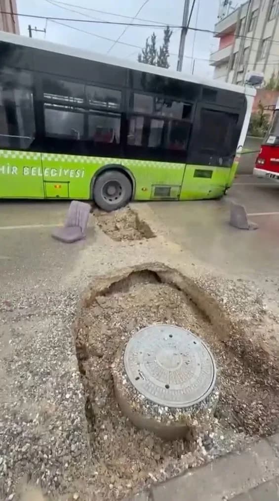 Adana Yüreğir ilçesinde yağış sonrası oluşan çukura düşen belediye otobüsü ekipler tarafından çıkarılıyor