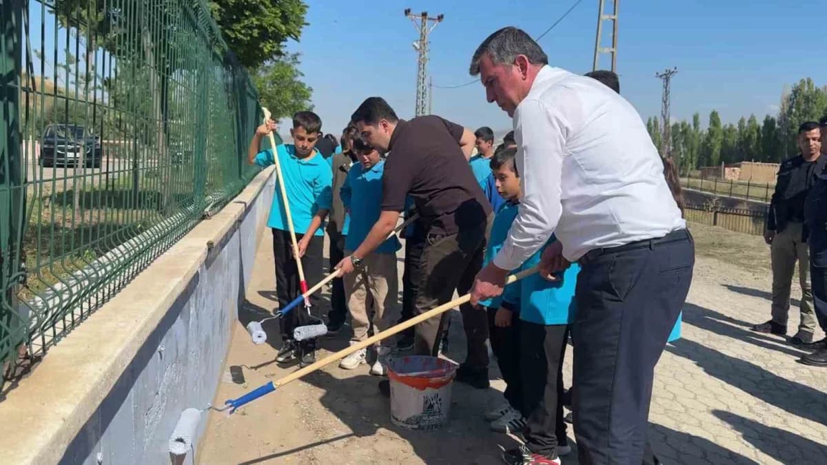 Altınyayla Şehit Zekeriya Demirkaynak Ortaokulu bahçesinde öğrenciler ve yöneticiler duvar boyama ve çevre temizliği yap