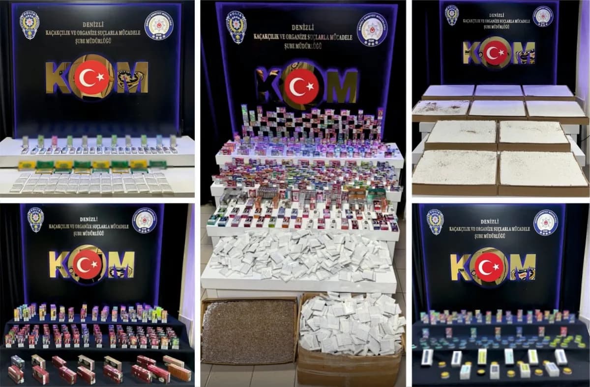 Denizli polis ekipleri kaçak tütün ve mamulleri operasyonunda ele geçirilen ürünlerle poz veriyor