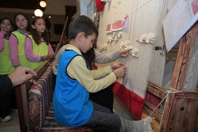 Her ziyaretçi ilmek ilmek Türk Bayrağı halısı dokuyor