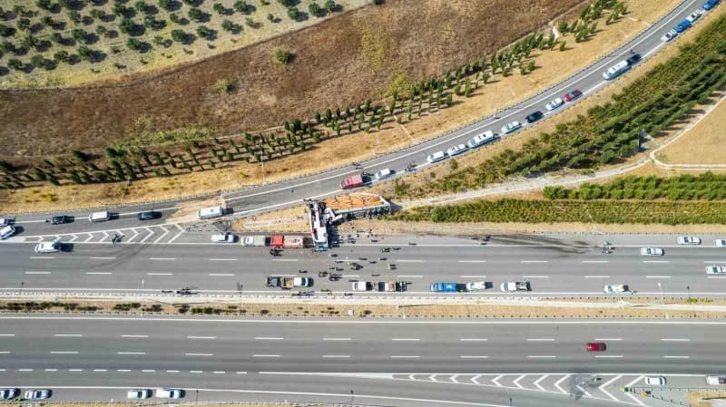 Devrilen yolcu otobüsü ve yoldan çıkan tır çekiciler yardımıyla olay yerinden kaldırılıyor.