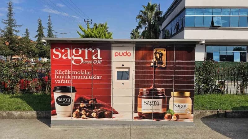 Sagra 1936 mağazasında PUDO akıllı kargo teslimat cihazı ve müşteriler